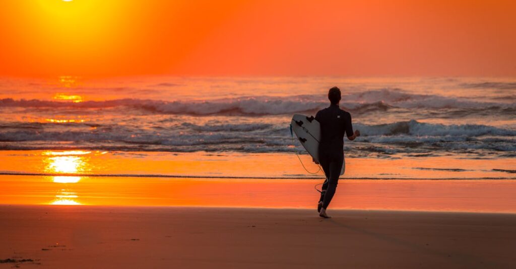 Silhouette of Surfer Running Towards Sea